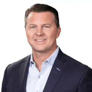Professional headshot of Joe Harris, Chief Operating Officer at Morgan Financial, in a navy blazer and light blue shirt.