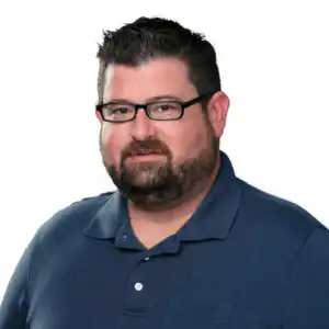 Professional headshot of Robert Valdes, Underwriter at Morgan Financial, wearing glasses and a navy polo shirt.