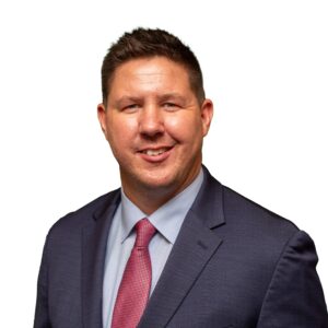 Professional headshot of Rob Forsyth, Director of Operations at Morgan Financial, wearing a navy suit and red tie.