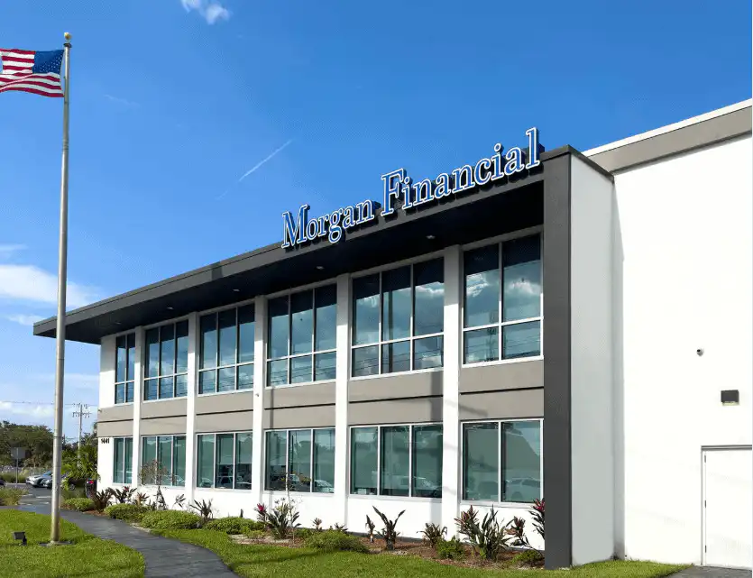 Morgan Financial headquarters building in Florida with an American flag flying in front.