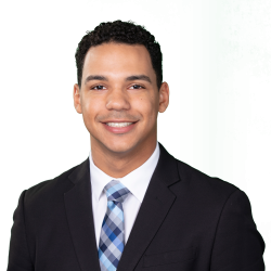 Professional headshot of Nathan Santa, Digital Marketing Strategist at Morgan Financial, wearing a suit and plaid tie.