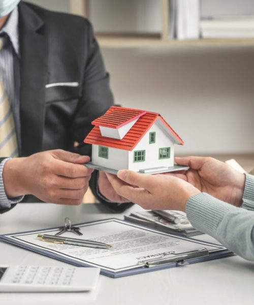 real-estate-brokers-offer-home-designs-for-clients-to-trade-with-a-mortgage-loan-contract.jpg